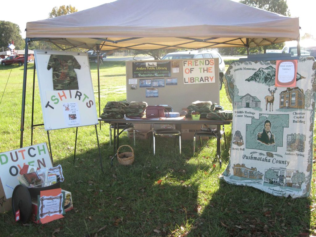 Picture of a Friends booth selling items to raise money.